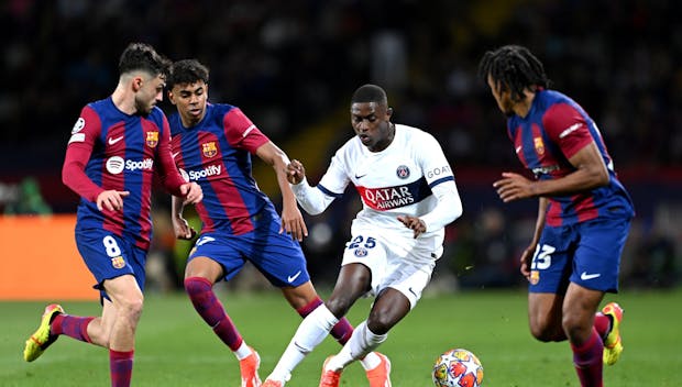 BARCELONA, SPAIN - APRIL 16: Nuno Mendes of Paris Saint-Germain battles for possession with Pedri, Lamine Yamal and Jules Kounde of FC Barcelona during the UEFA Champions League quarter-final second leg match between FC Barcelona and Paris Saint-Germain at Estadi Olimpic Lluis Companys on April 16, 2024 in Barcelona, Spain. (Photo by David Ramos/Getty Images)